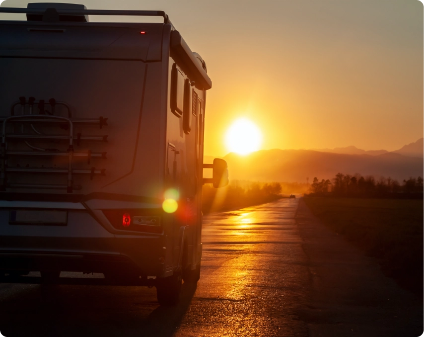 RV driving into sunset